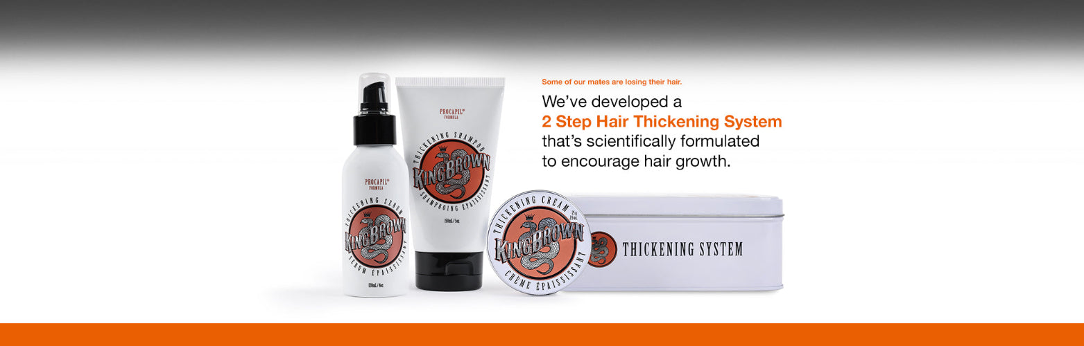 Hair thickening system products with packaging on a gradient background